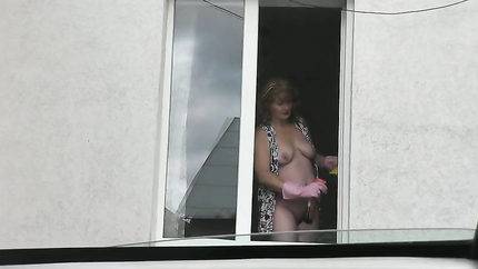 MILF in bathrobe without panties and bra washes window of apartment. Nude in public. Naked in public. Big natural tits MILF (2026 | SD)